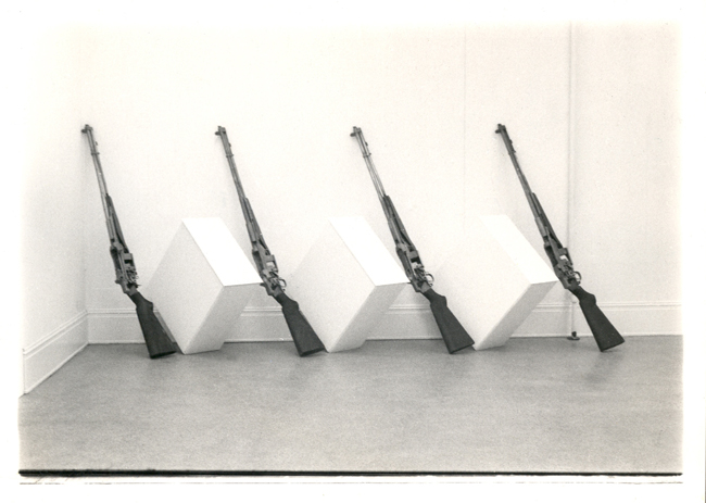 Oversized demonstration rifle models and pedestals are used in this piece
