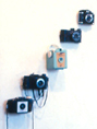 This detail of an installation of plastic cameras from Harry Anderson's 1978 show of  art work at the Woods-Gerry Gallery of the Rhode Island School of Design is your link to installation photographs of the exhibition.